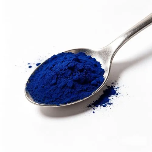 blue spirulina powder in spoon blue spirulina powder in spoon